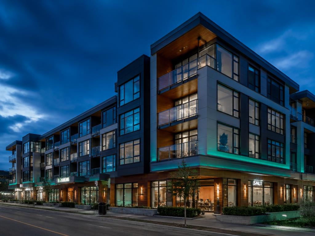 Modern multi-storey high-performance building facade in BC at twilight.