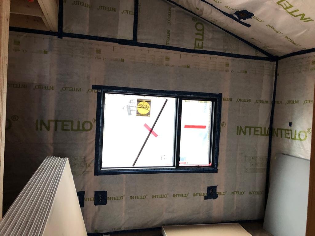 Blown-in attic insulation topped up to current R-50 levels in a Lower Mainland home