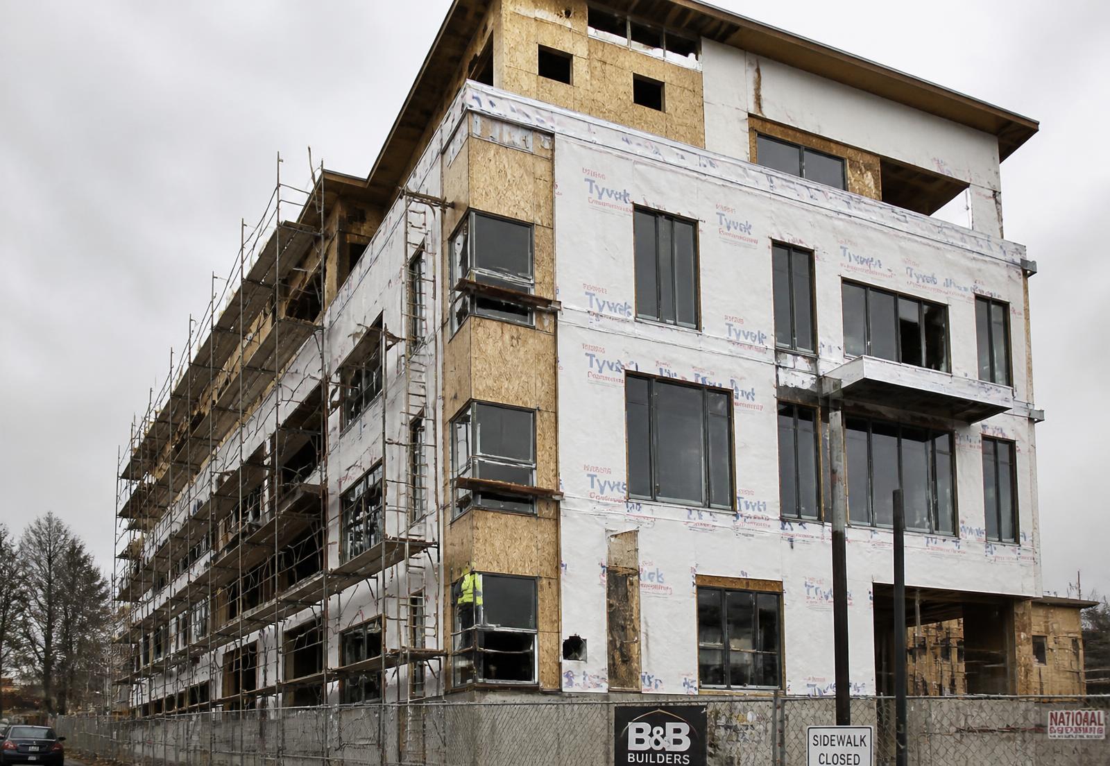 Multi-storey commercial building under construction with exposed sheathing and a wrapped air barrier
